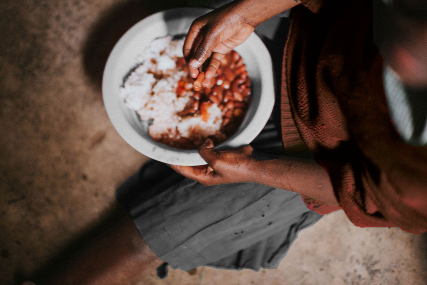 A child eating a meal provided by No Hungry Children