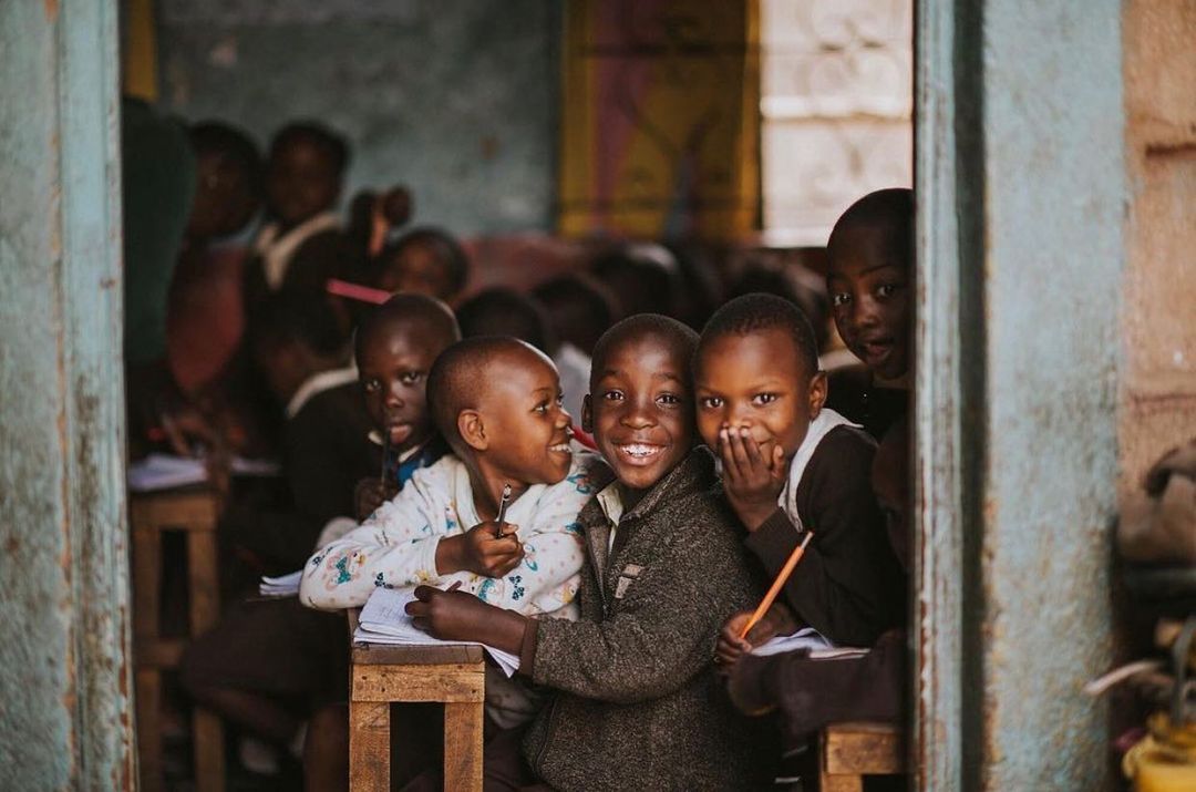 Children smiling together in a No Hungry Children classroom